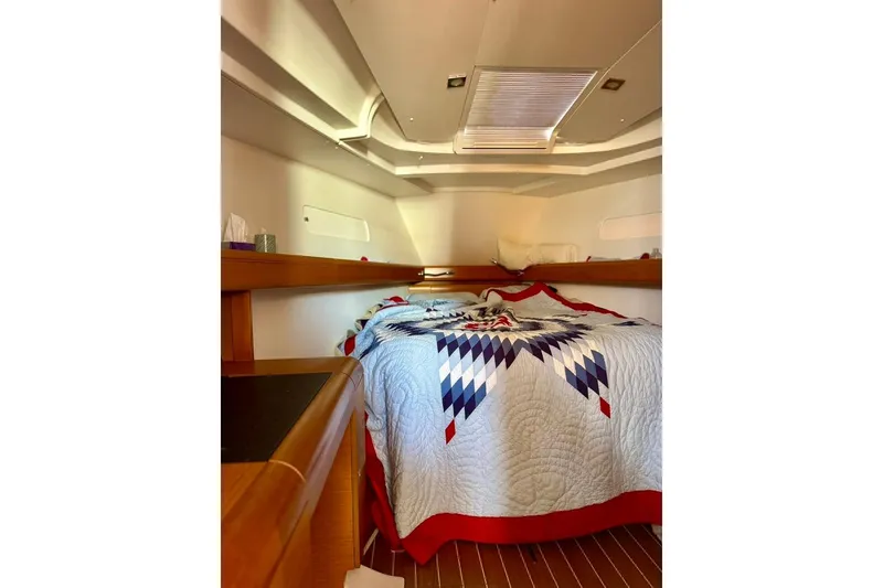 Slide: The Image of Cozy cabin interior of 2017 Jeanneau Sun Odyssey 449 sailboat with patterned bedding. - 46