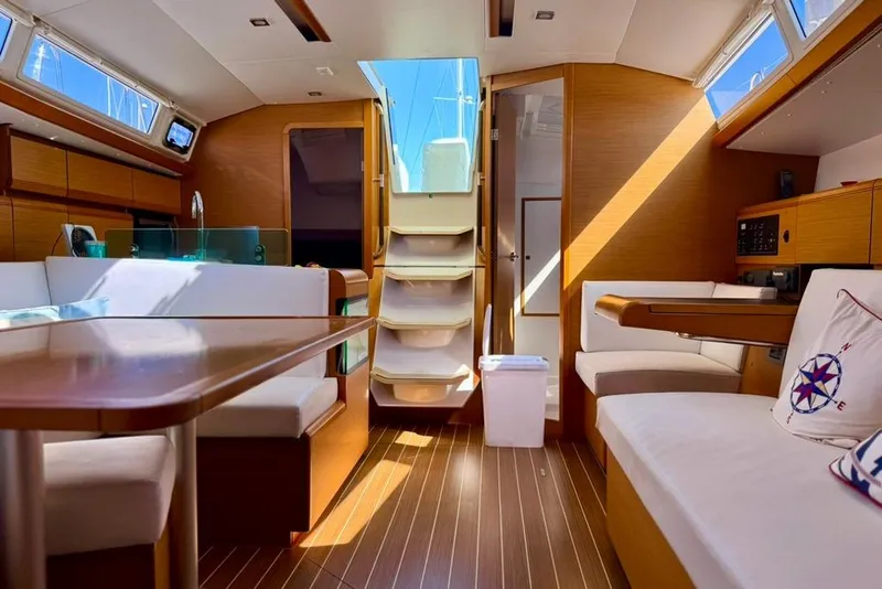 Slide: The Image of Interior of 2017 Jeanneau Sun Odyssey 449 yacht, featuring modern wood finish and seating area. - 51