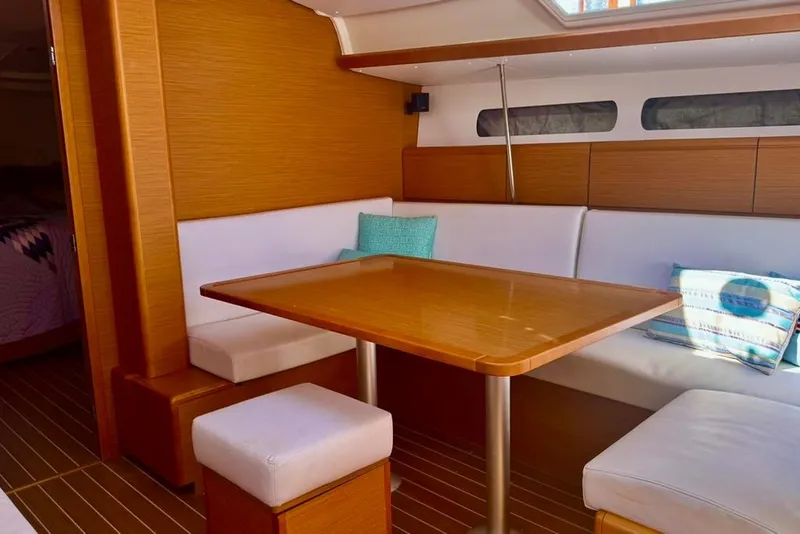 Slide: The Image of Interior of 2017 Jeanneau Sun Odyssey 449 yacht with cozy seating and wooden table. - 53