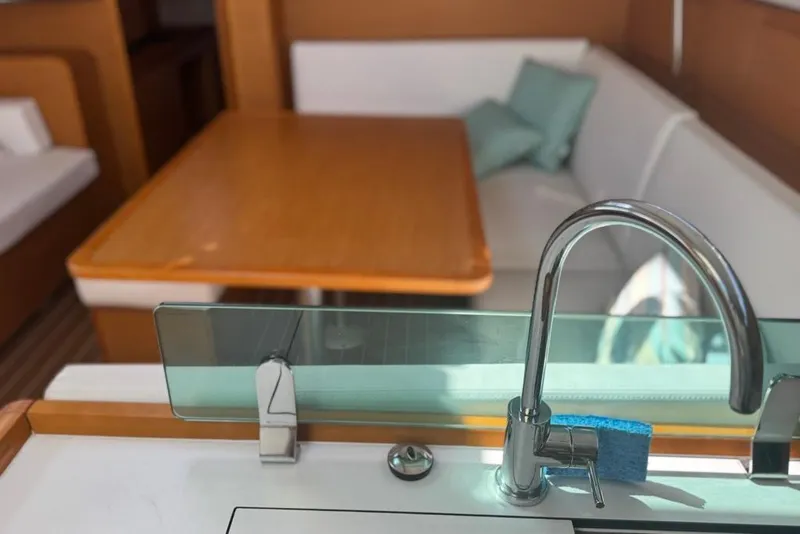 Slide: The Image of Interior of 2017 Jeanneau Sun Odyssey 449 yacht with modern kitchen and seating area. - 55