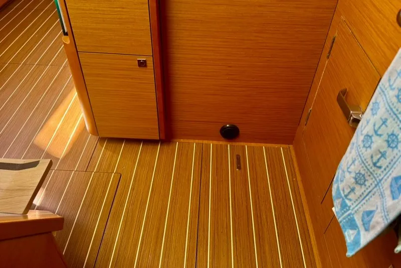 Slide: The Image of Interior of 2017 Jeanneau Sun Odyssey 449 yacht with wooden flooring and cabinetry. - 57