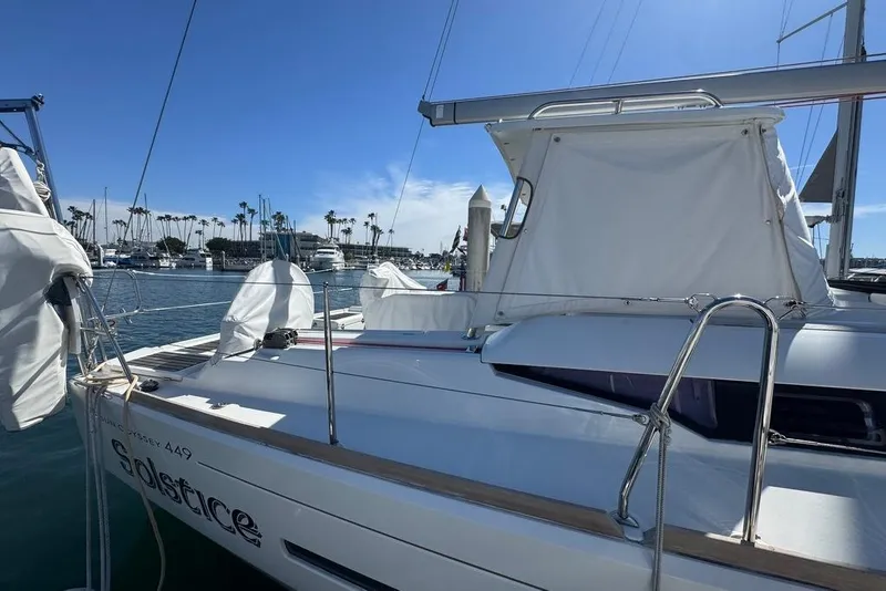Slide: The Image of 2017 Jeanneau Sun Odyssey 449 sailboat docked in a marina under clear blue skies. - 6