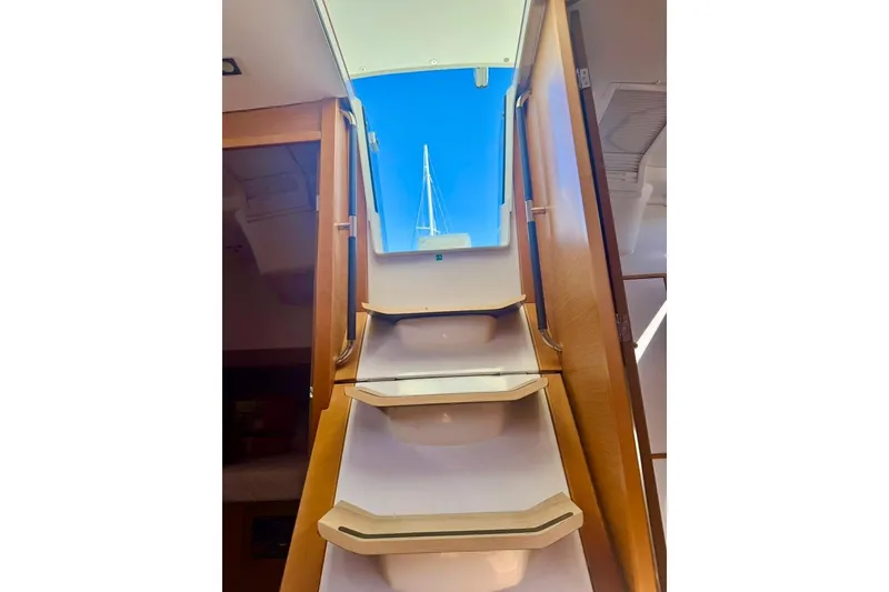 Slide: The Image of Interior view of 2017 Jeanneau Sun Odyssey 449 yacht, showcasing stairs leading to deck. - 66