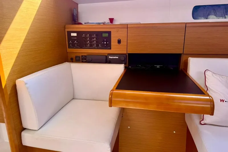 Slide: The Image of Interior of 2017 Jeanneau Sun Odyssey 449 yacht, featuring a navigation station and seating area. - 68