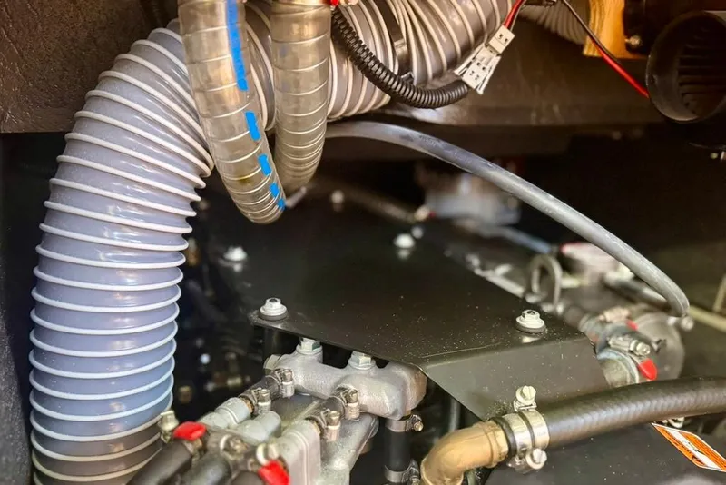 Slide: The Image of Engine compartment of a 2017 Jeanneau Sun Odyssey 449 sailboat, featuring hoses and mechanical components. - 73