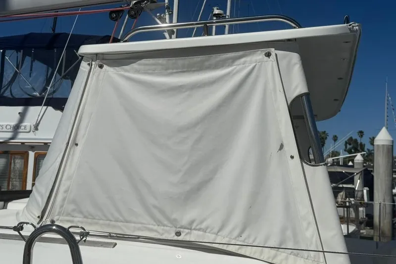 Slide: The Image of 2017 Jeanneau Sun Odyssey 449 sailboat with white canvas cover in marina. - 9