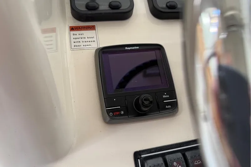 Slide: The Image of Control panel of a 2007 Pursuit C 310 Center Console boat with Raymarine display. - 13