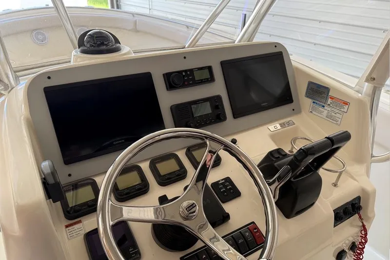 Slide: The Image of 2007 Pursuit C 310 Center Console dashboard with steering wheel and navigation displays. - 14