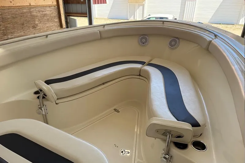 Slide: The Image of 2007 Pursuit C 310 Center Console boat interior with cushioned seating and cup holders. - 18