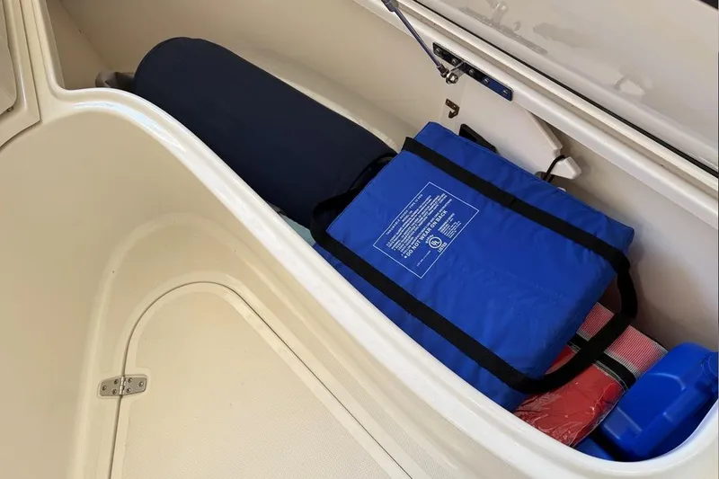 Slide: The Image of Storage compartment of 2007 Pursuit C 310 Center Console with safety gear. - 19