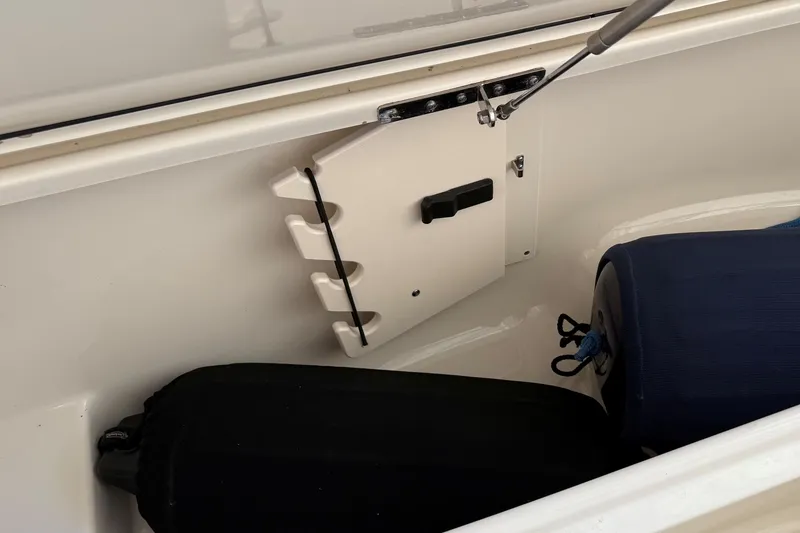 Slide: The Image of Storage compartment of a 2007 Pursuit C 310 Center Console boat with fenders. - 21