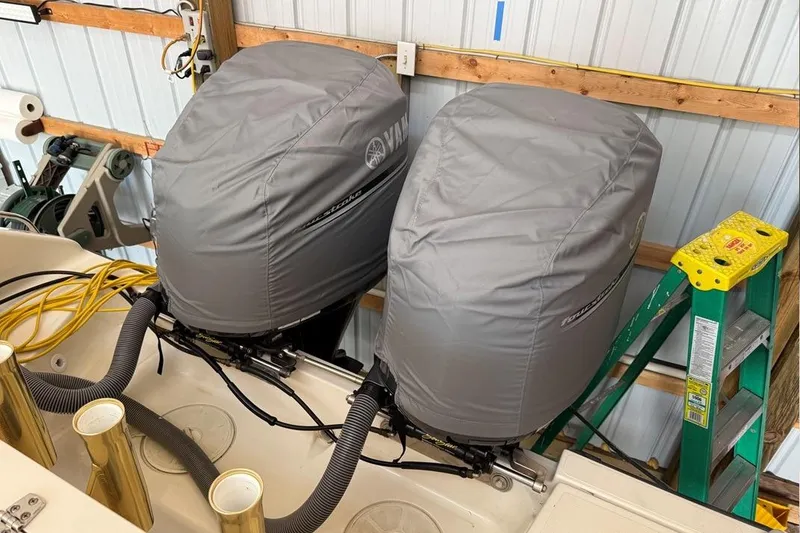 Slide: The Image of 2007 Pursuit C 310 Center Console with covered outboard motors in a storage area. - 24
