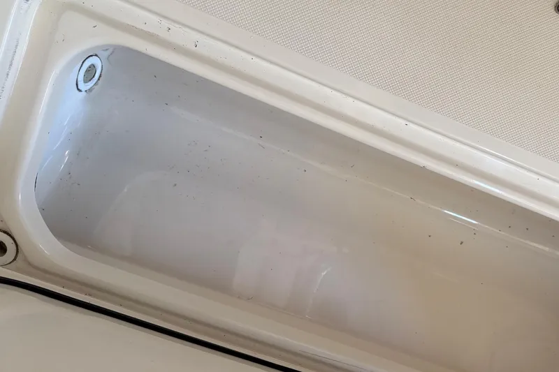 Slide: The Image of Livewell compartment on a 2007 Pursuit C 310 Center Console boat. - 28