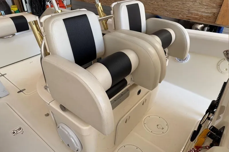 Slide: The Image of 2007 Pursuit C 310 Center Console boat seats with black and white upholstery. - 37