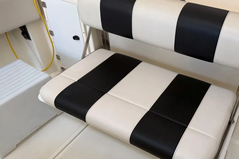 Slide: The Image of Black and white striped seat on 2007 Pursuit C 310 Center Console boat. - 40