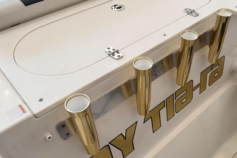 Slide: The Image of 2007 Pursuit C 310 Center Console with gold rod holders and storage compartment. - 41