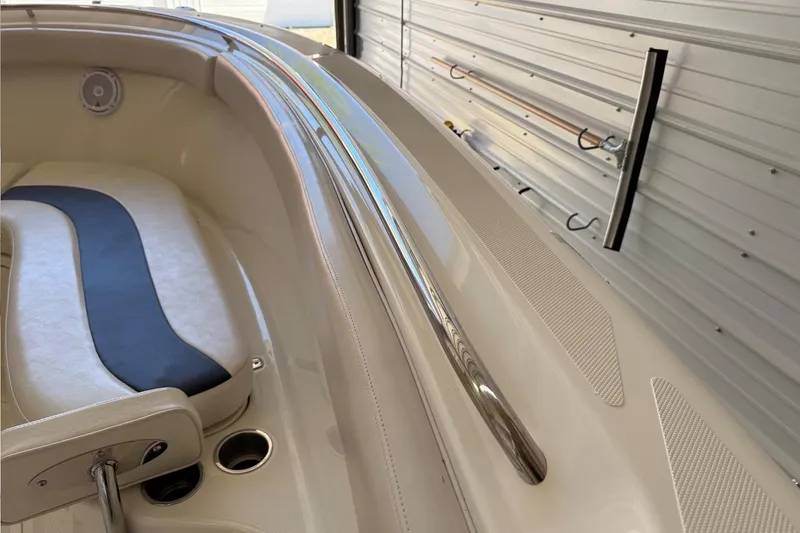 Slide: The Image of 2007 Pursuit C 310 Center Console boat interior with cushioned seating and stainless steel rail. - 42