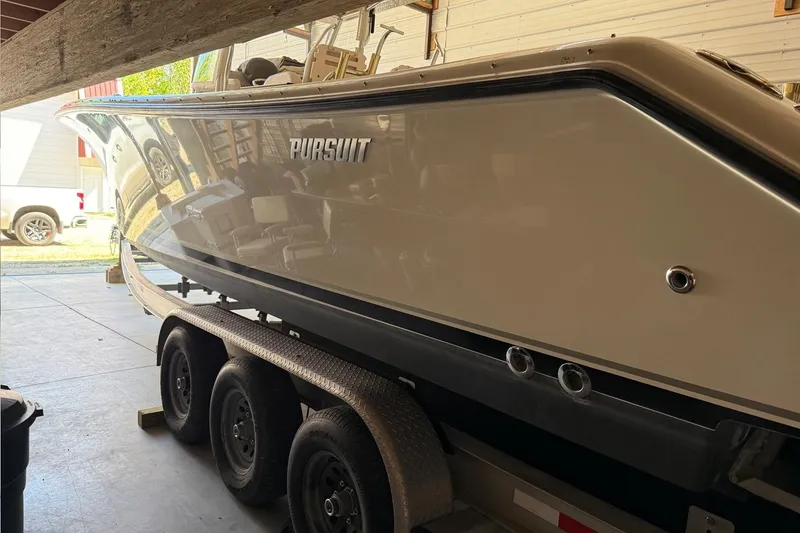 Slide: The Image of 2007 Pursuit C 310 Center Console boat on trailer in garage. - 43