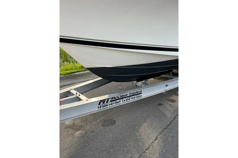 Slide: The Image of 2007 Pursuit C 310 Center Console boat on McClain trailer, parked on pavement. - 44