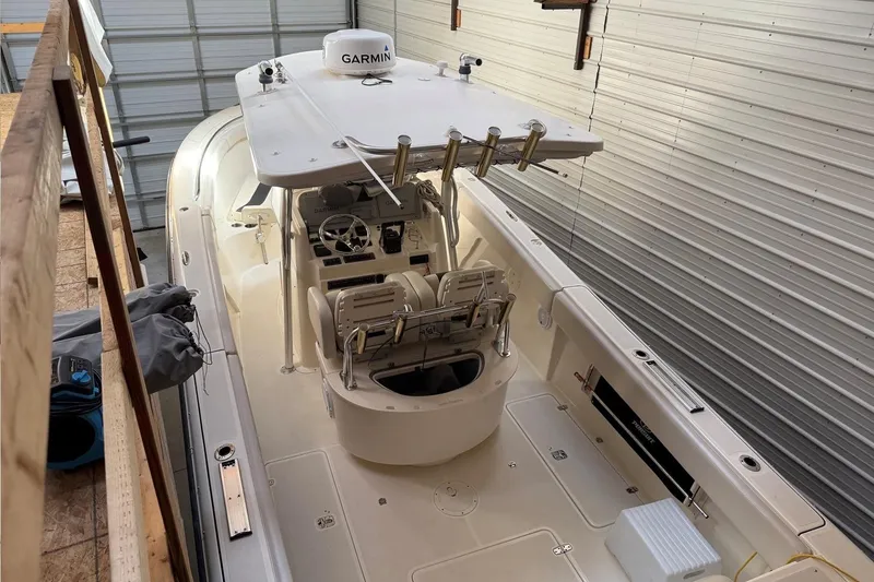 Slide: The Image of 2007 Pursuit C 310 Center Console boat in storage, featuring Garmin equipment. - 48