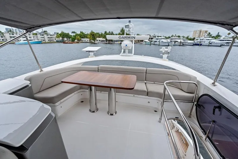Slide: The Image of Luxurious 2020 Princess S62 yacht deck with seating and table, overlooking marina. - 20