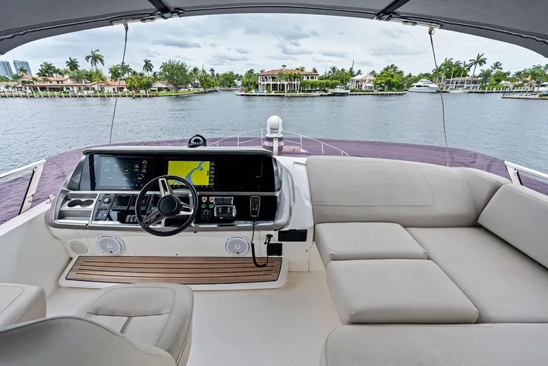 Slide: The Image of Luxurious 2020 Princess S62 yacht helm with plush seating and scenic waterfront view. - 24