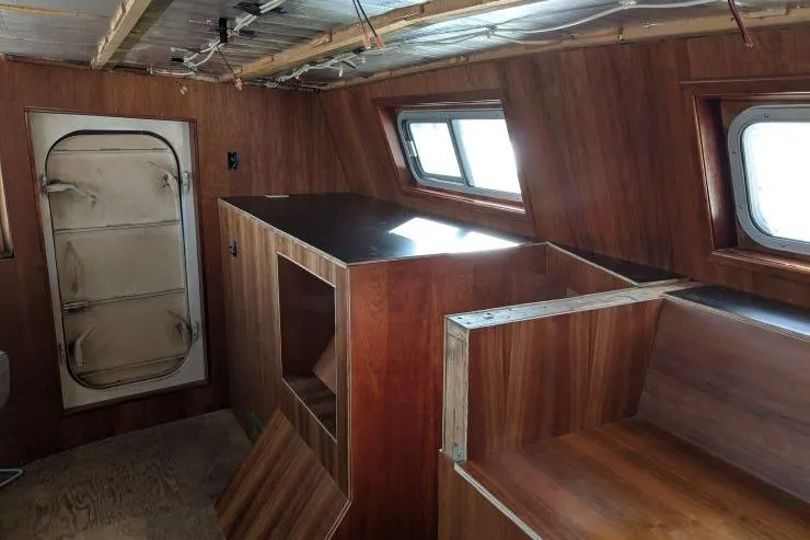 Slide: The Image of 1977 Commercial Expedition Trawler interior with wood paneling and windows. - 10