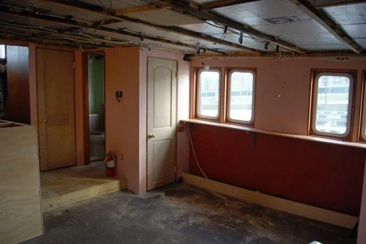Slide: The Image of Interior of a 1977 Commercial Expedition Trawler with wooden doors and windows. - 12