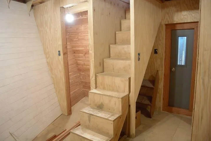 Slide: The Image of Wooden interior of a 1977 Commercial Expedition Trawler with stairs and door. - 16