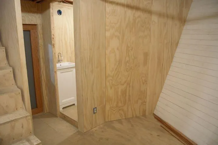 Slide: The Image of Interior of a 1977 Commercial Expedition Trawler with wooden walls and a small sink area. - 18