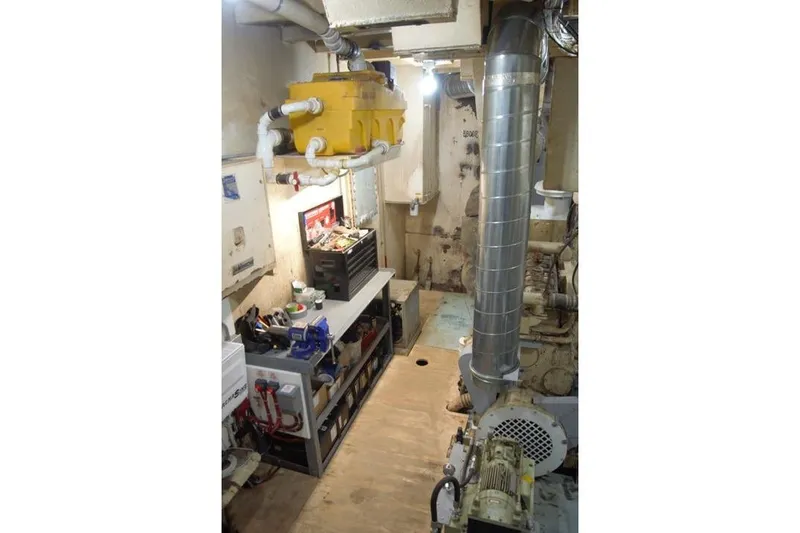Slide: The Image of Engine room of a 1977 Commercial Expedition Trawler with tools and equipment. - 22