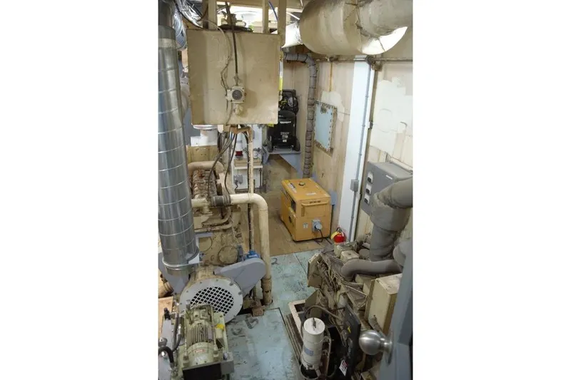 Slide: The Image of Engine room of a 1977 Commercial Expedition Trawler with machinery and equipment. - 24
