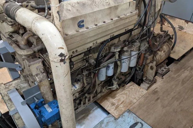 Slide: The Image of Engine room of a 1977 Commercial Expedition Trawler with visible machinery and components. - 27
