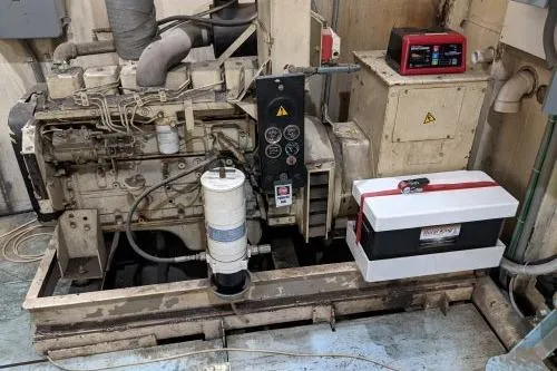 Slide: The Image of Engine room of a 1977 Commercial Expedition Trawler with machinery and control panels. - 29