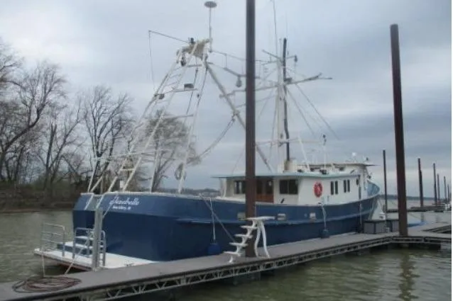Slide: The Image of 1977 Commercial Expedition Trawler docked on a cloudy day, showcasing its robust design. - 5
