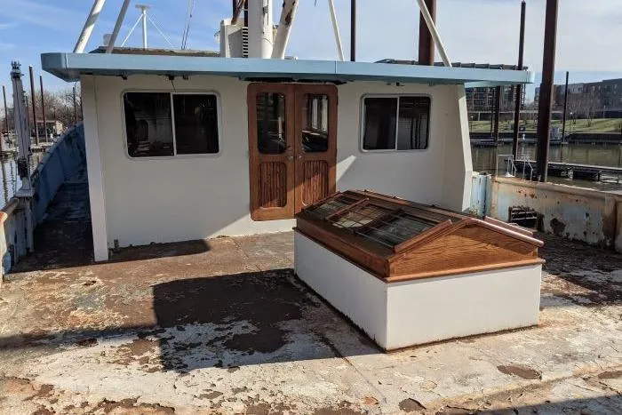 Slide: The Image of 1977 Commercial Expedition Trawler with weathered deck and wooden cabin doors. - 6