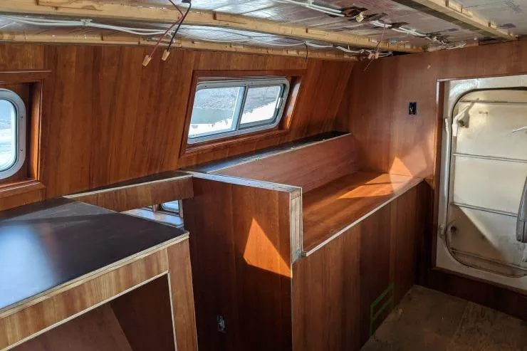 Slide: The Image of Interior of a 1977 Commercial Expedition Trawler with wooden paneling and windows. - 9