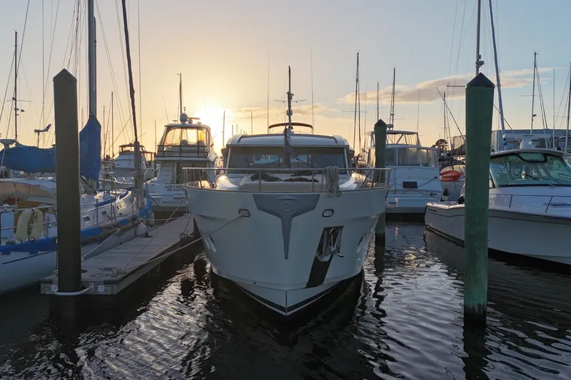 Slide: The Image of 2019 Greenline 48 Coupe yacht docked at marina during sunset. - 1
