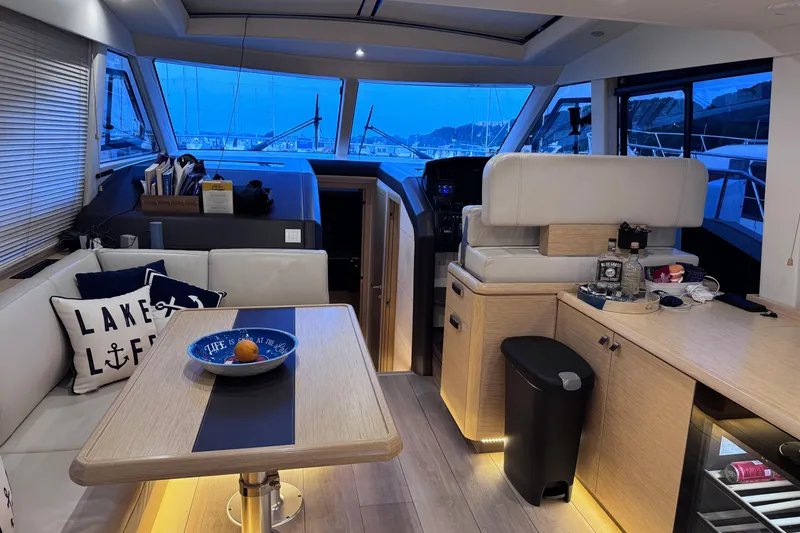 Slide: The Image of Interior of 2019 Greenline 48 Coupe yacht with modern seating and nautical decor. - 14