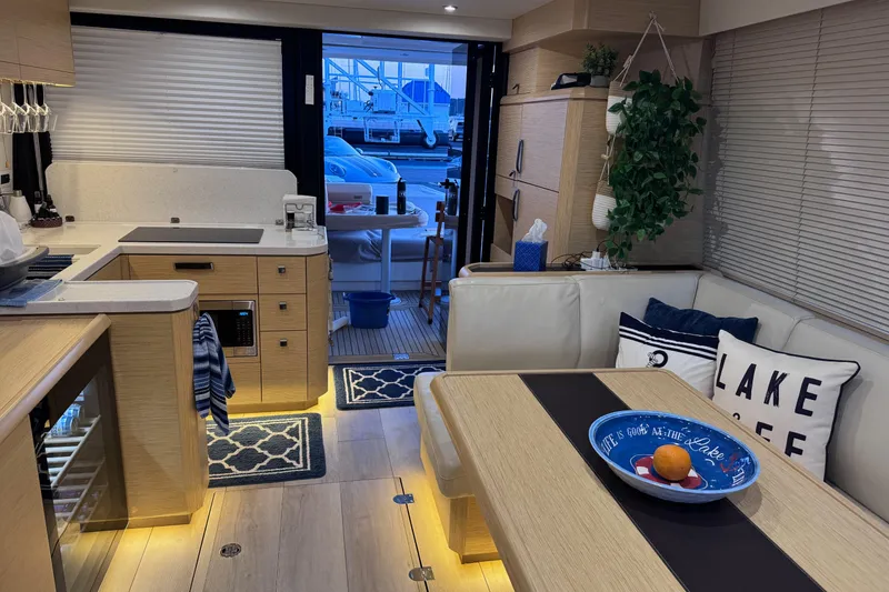 Slide: The Image of Luxurious interior of 2019 Greenline 48 Coupe yacht with modern kitchen and cozy seating area. - 29