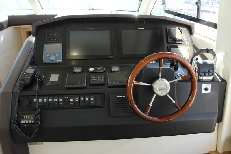 Slide: The Image of 2019 Greenline 48 Coupe helm with wooden steering wheel and electronics. - 30