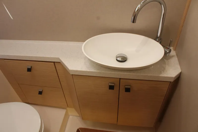 Slide: The Image of Modern bathroom in 2019 Greenline 48 Coupe with sink and wooden cabinets. - 48