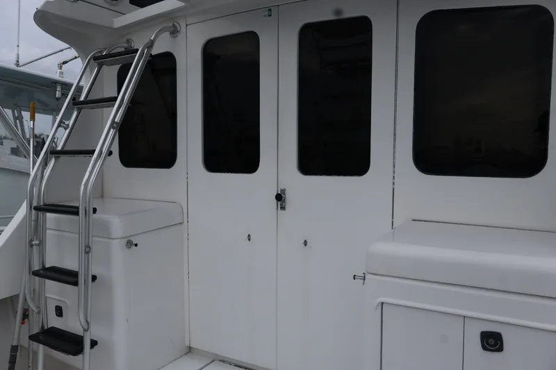 Slide: The Image of 1994 Luhrs 32 Convertible boat with ladder and cabin doors. - 71