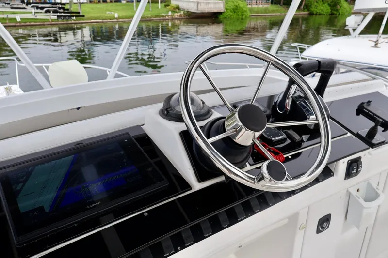 Slide: The Image of Steering wheel and controls of a 1994 Luhrs 32 Convertible boat. - 56