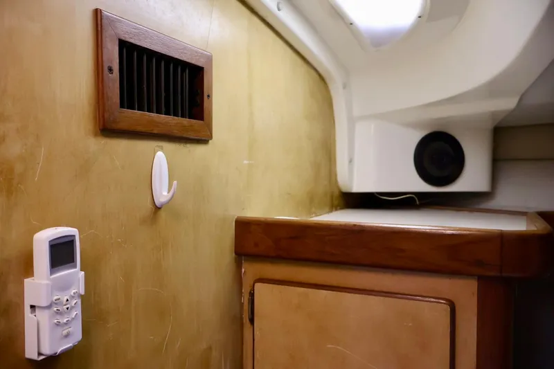 Slide: The Image of Interior of 1994 Luhrs 32 Convertible boat with wooden paneling and control panel. - 46