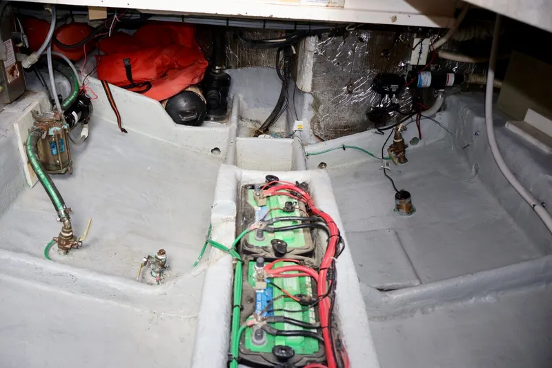 Slide: The Image of Engine compartment of a 1994 Luhrs 32 Convertible boat, showing batteries and wiring. - 66