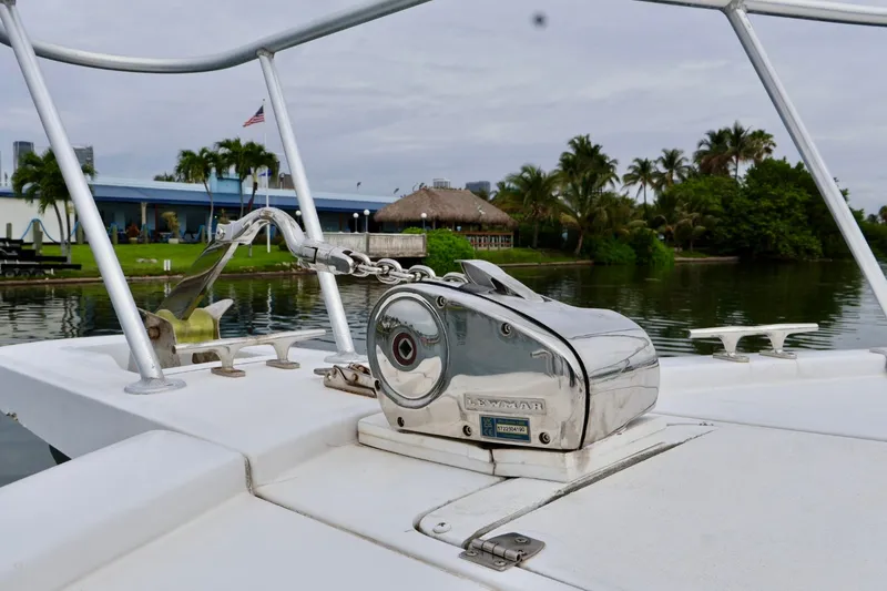Slide: The Image of 1994 Luhrs 32 Convertible boat deck with anchor winch, near tropical shoreline. - 67