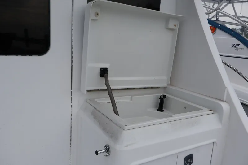 Slide: The Image of 1994 Luhrs 32 Convertible boat sink with open lid and faucet. - 72