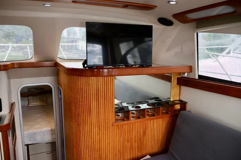 Slide: The Image of Interior of 1994 Luhrs 32 Convertible yacht with TV and cozy seating area. - 60