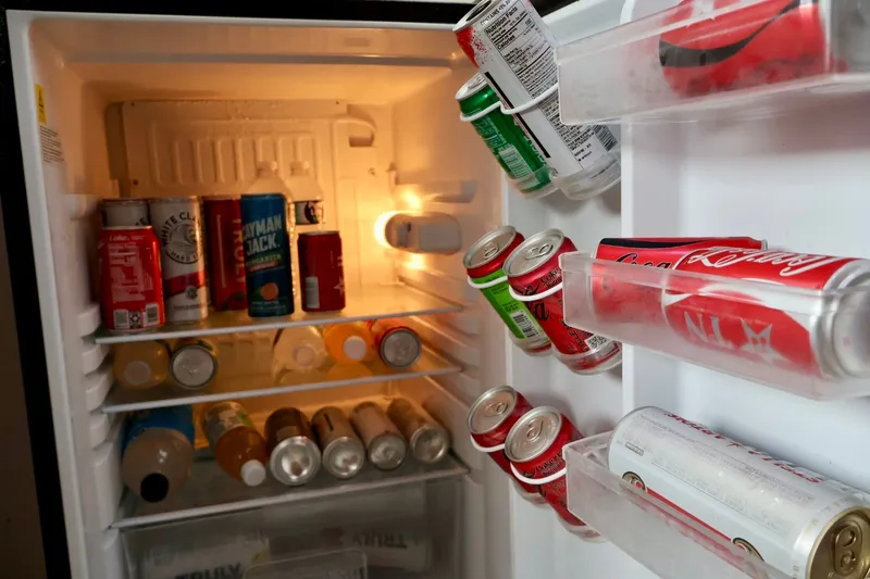 Slide: The Image of Mini fridge stocked with assorted beverages on a 1994 Luhrs 32 Convertible boat. - 62